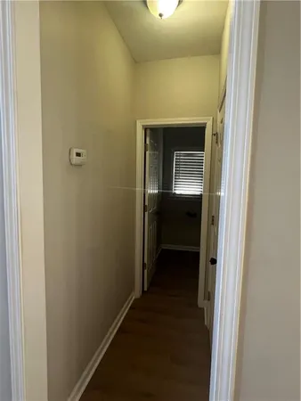 a bathroom with a toilet and a mirror