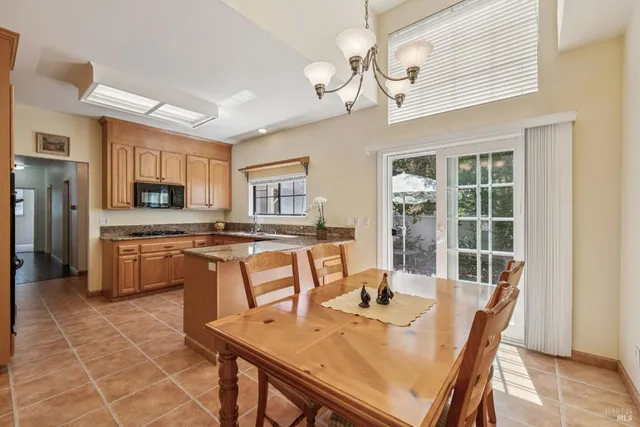 a view of a dining room with furniture and chandelier