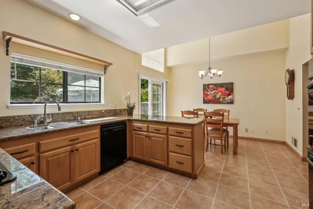 a view of a dining room with furniture and a chandelier