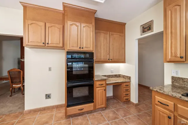 a kitchen with a sink and a stove top oven