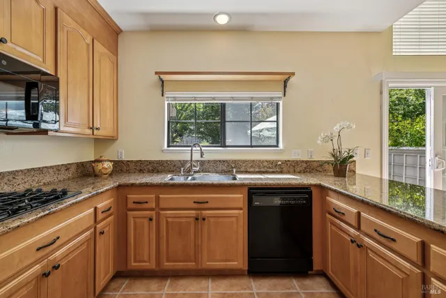 a kitchen with granite countertop cabinets and steel stainless steel appliances