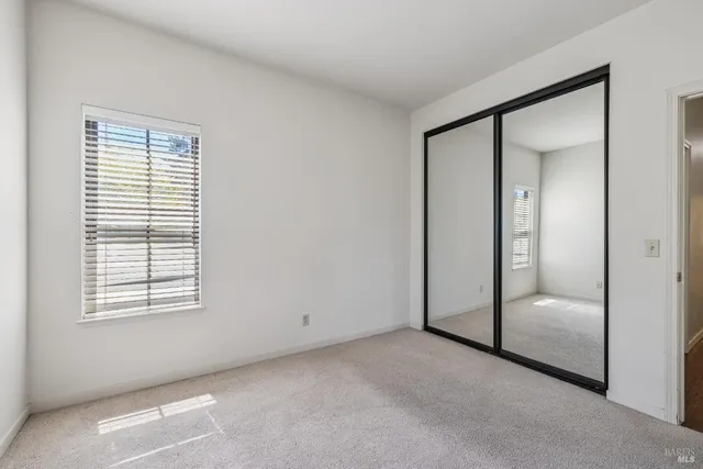 a view of a patio with table and chairs under an umbrella
