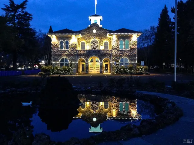 a view of a grassy field with trees in the background