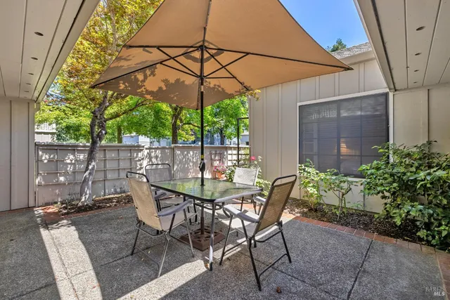 an empty room with chandelier and glass door