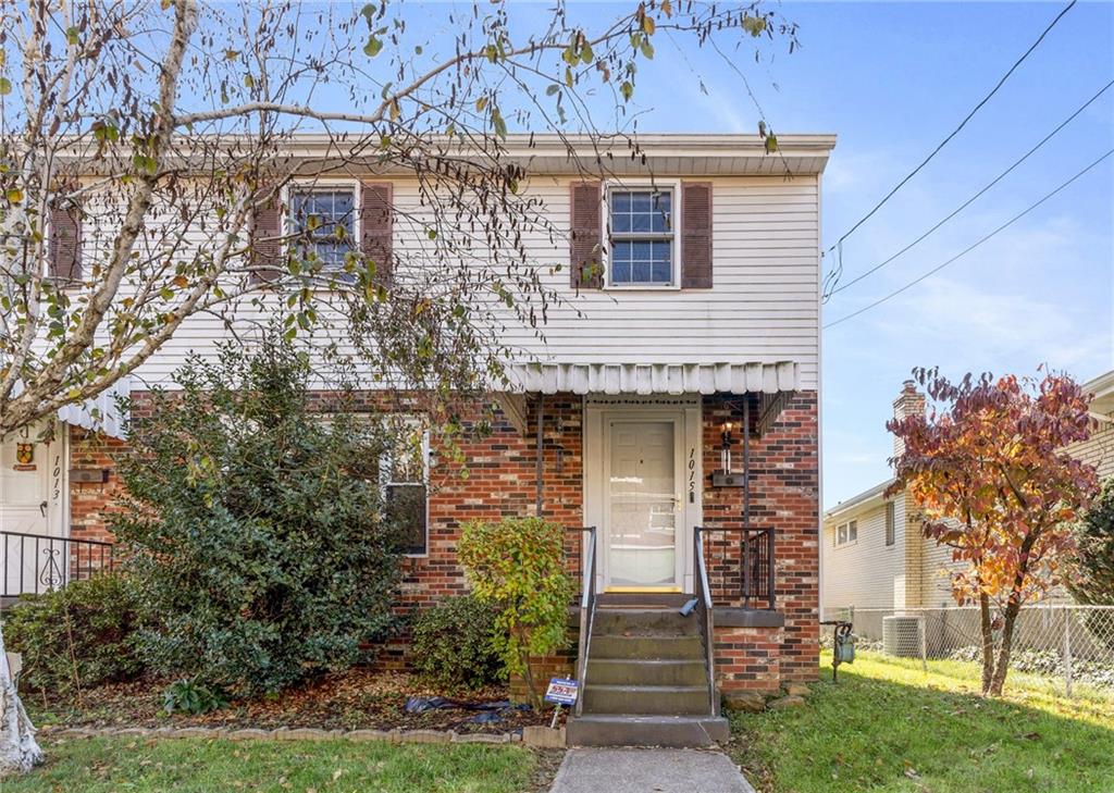 1015 1st Street McKees Rocks, PA 15136 - Photo 1 of 22 a front view of a house with garden