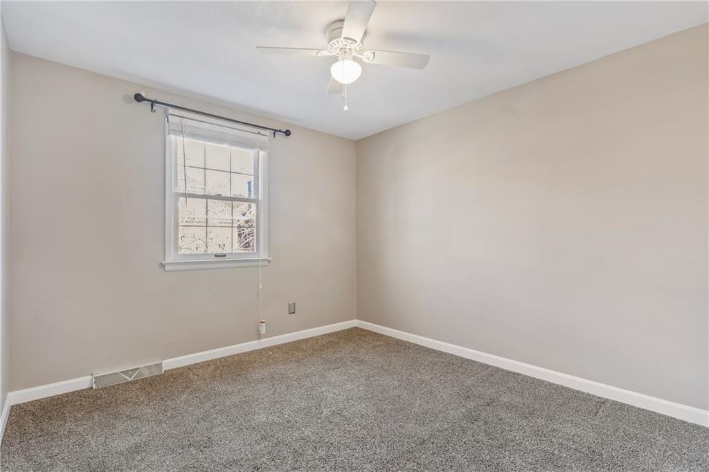 1015 1st Street McKees Rocks, PA 15136 - Photo 14 of 22 an empty room with windows and fan