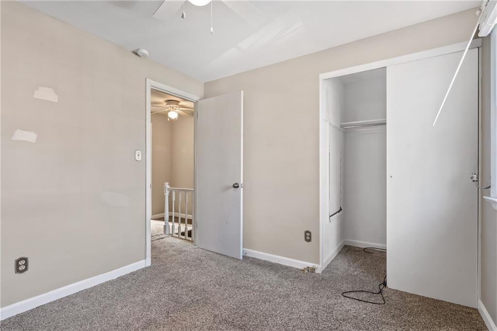 1015 1st Street McKees Rocks, PA 15136 - Photo 17 of 22 an empty room with closet and a chandelier fan