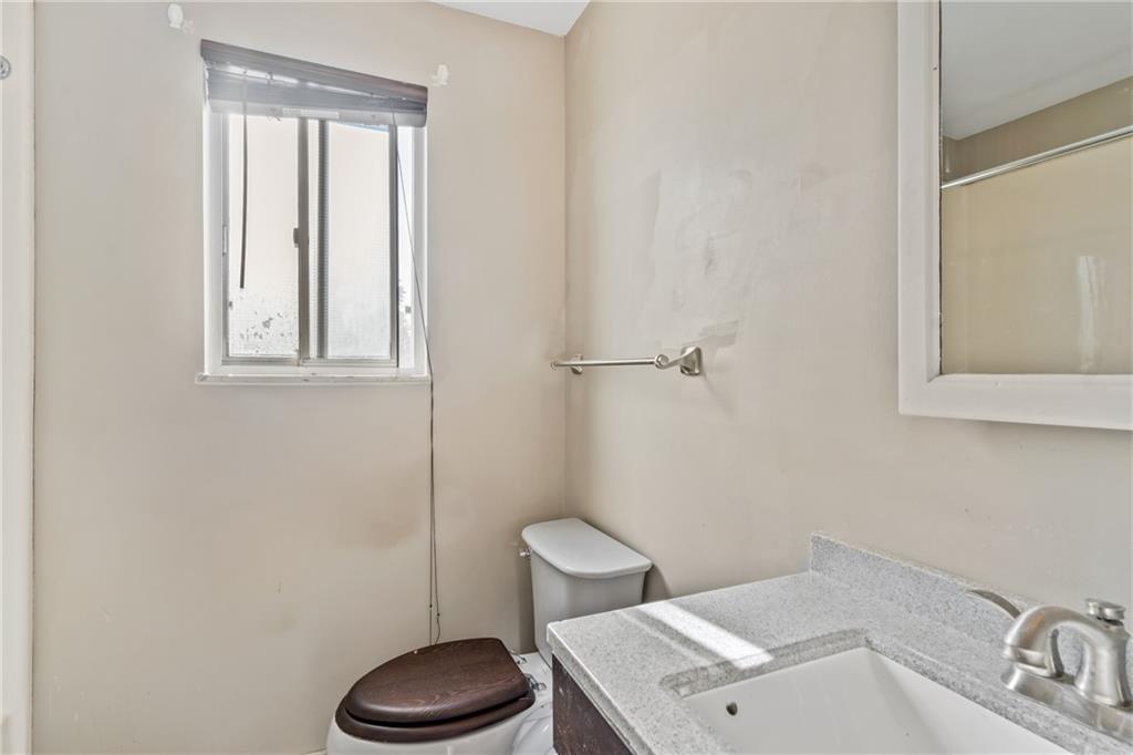 1015 1st Street McKees Rocks, PA 15136 - Photo 9 of 22 a bathroom with a toilet sink and mirror