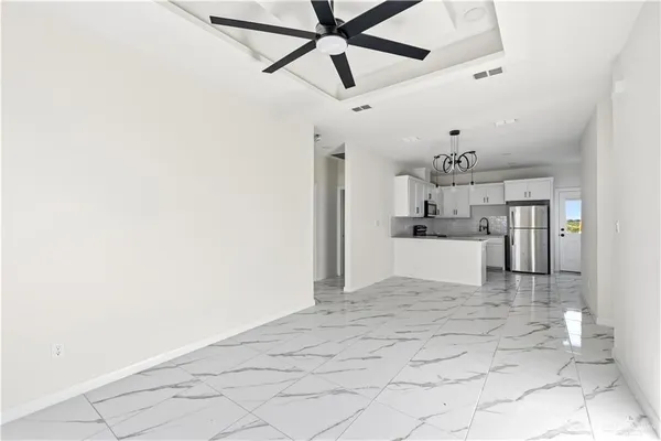 a view of a kitchen with a sink and cabinets