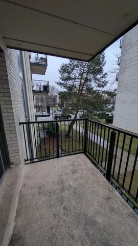 a view of a balcony with trees