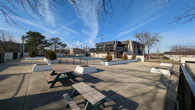 a view of a patio with dining table and chairs with wooden floor