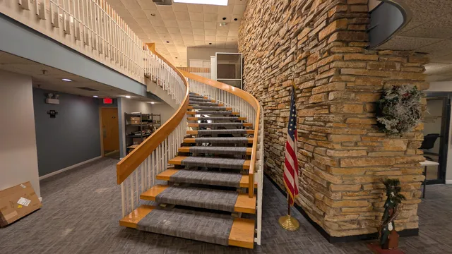 a lobby with furniture and a rug