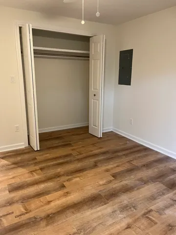 an empty room with wooden floor and a window