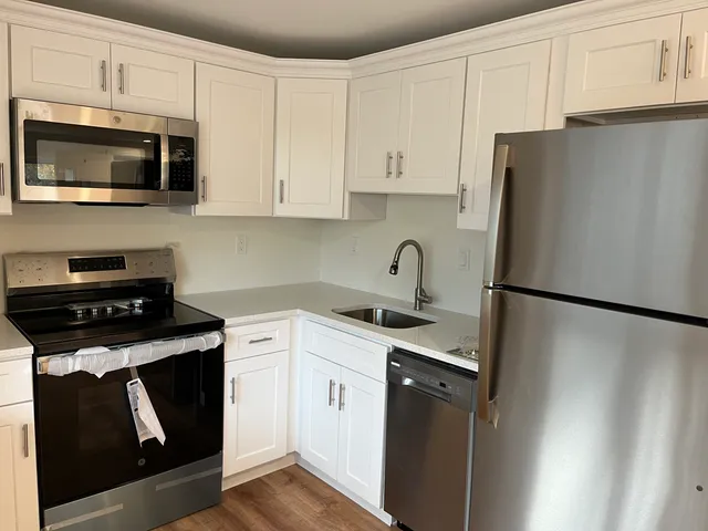 a kitchen with a refrigerator sink and microwave