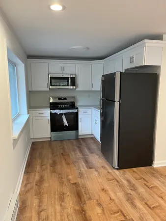 a kitchen with granite countertop a refrigerator and a stove