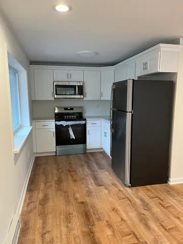 a kitchen with granite countertop a refrigerator and a stove