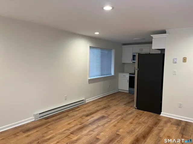 a view of an empty room with a kitchen