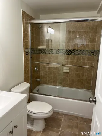 a bathroom with a shower and a toilet