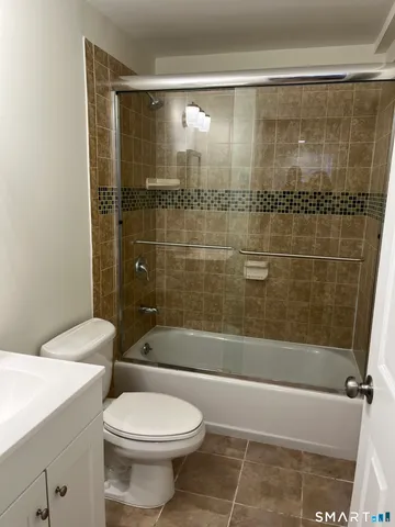 a bathroom with a shower and a toilet