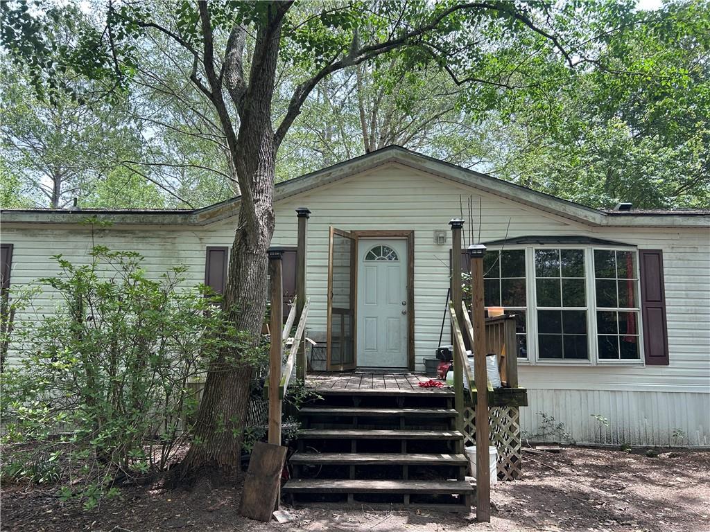 114 Jones Road Hortense, GA 31543 - Photo 2 of 25 a front view of a house with a garden
