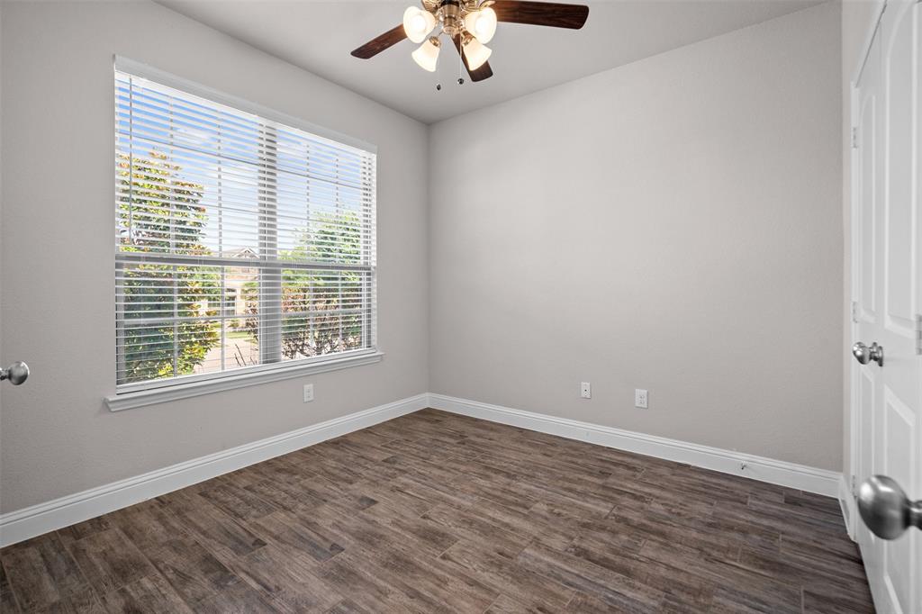 119 Happy Lane Red Oak, TX 75154 - Photo 19 of 37 Neutral wall tones featuring a window with horizontal blinds, wood-finish flooring, white baseboards, and a ceiling fan with integrated lighting