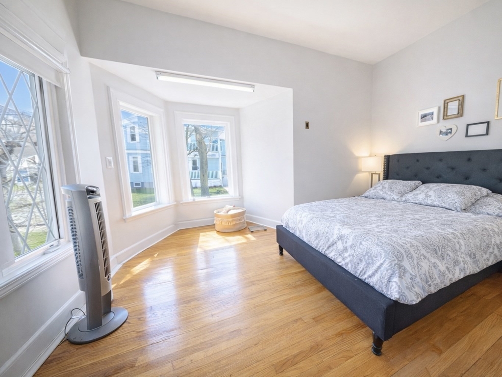 10 Guild Road Saugus, MA 01906 - Photo 16 of 32 a spacious bedroom with a bed and wooden floor