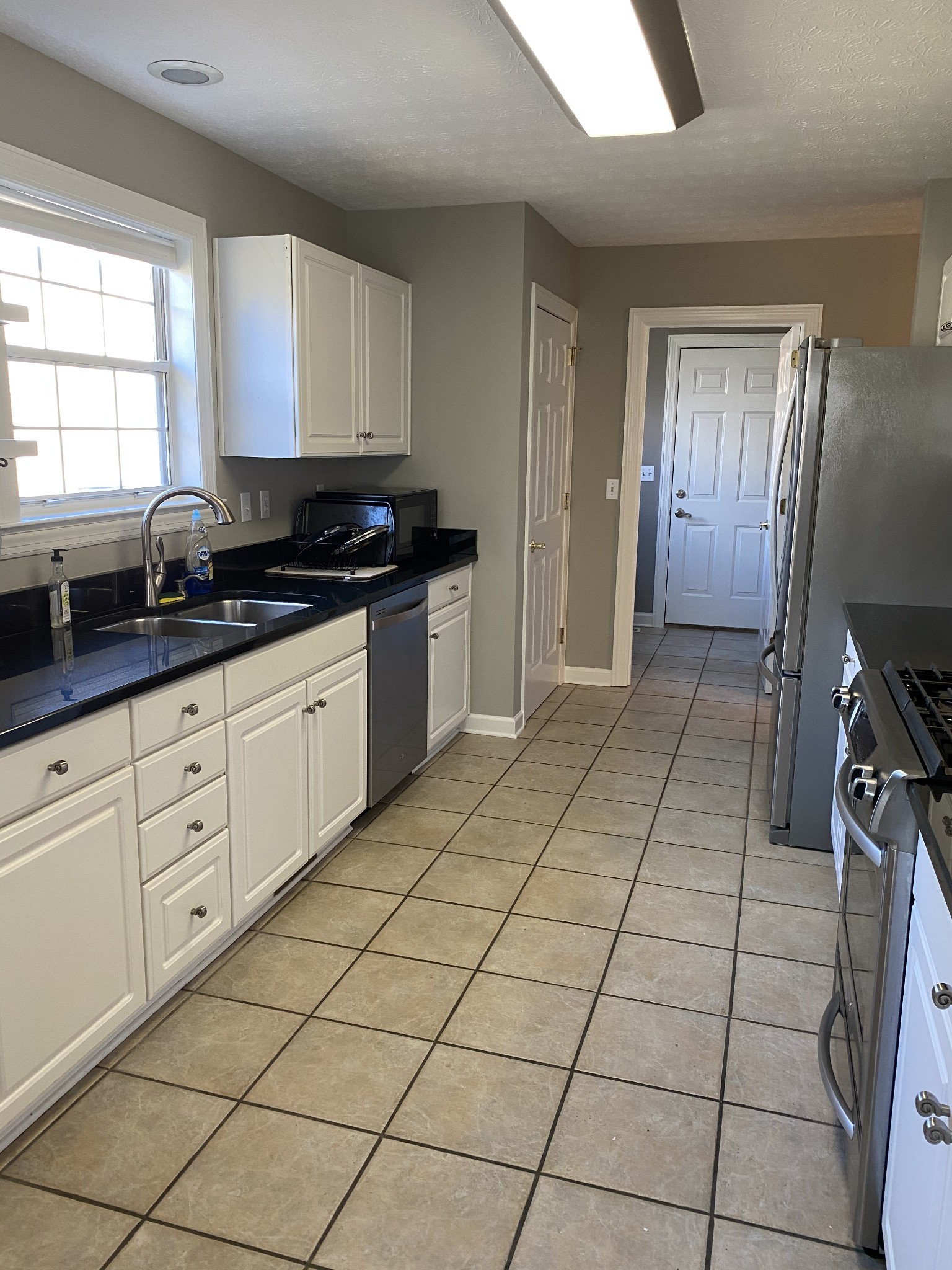 1045 Edgewater Circle Gallatin, TN 37066 - Photo 7 of 10 a kitchen with stainless steel appliances a sink window and cabinets