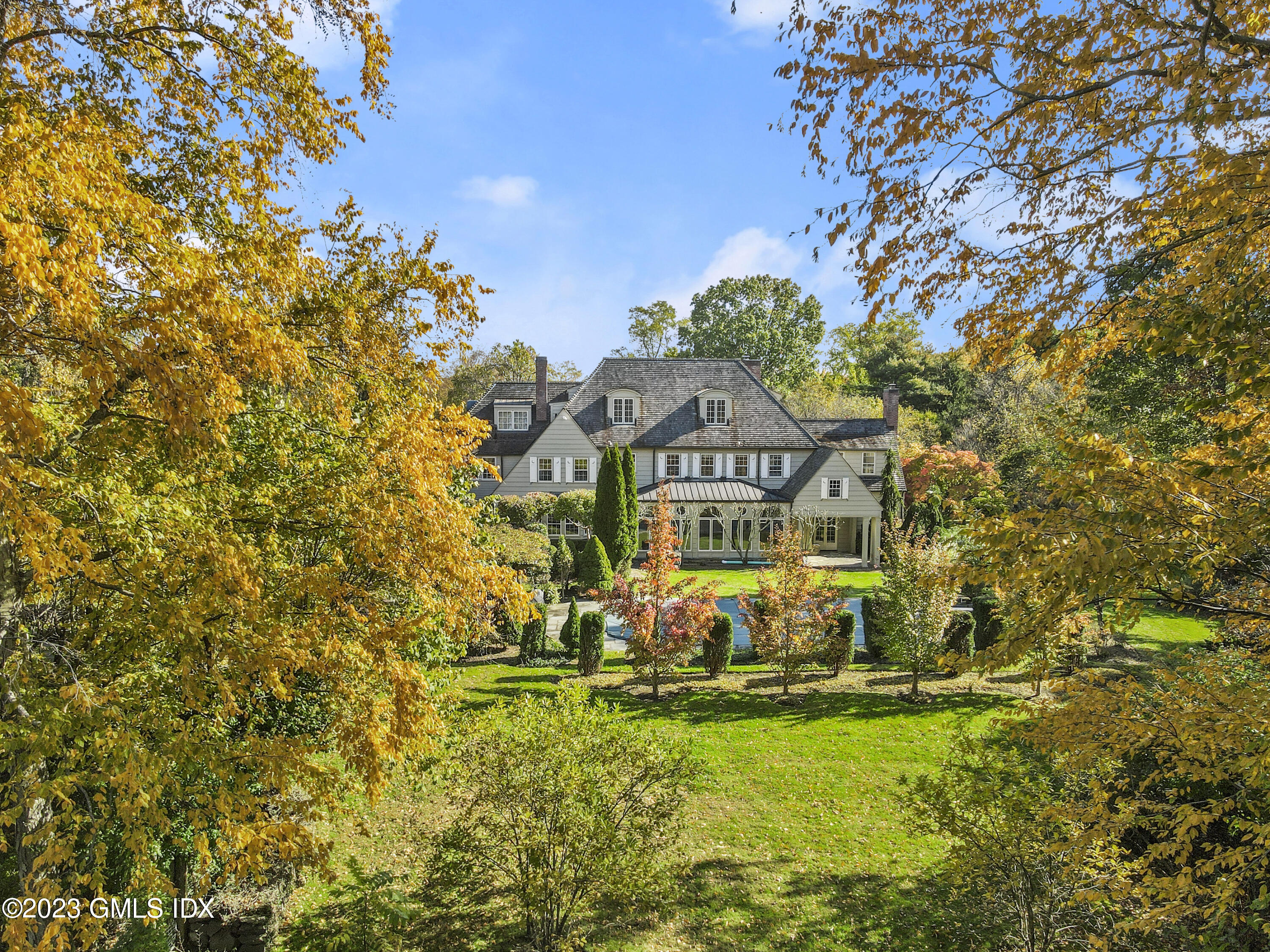 736 Lake Avenue Greenwich, CT 06830 - Photo 3 of 9 a view of a big yard with plants and large trees