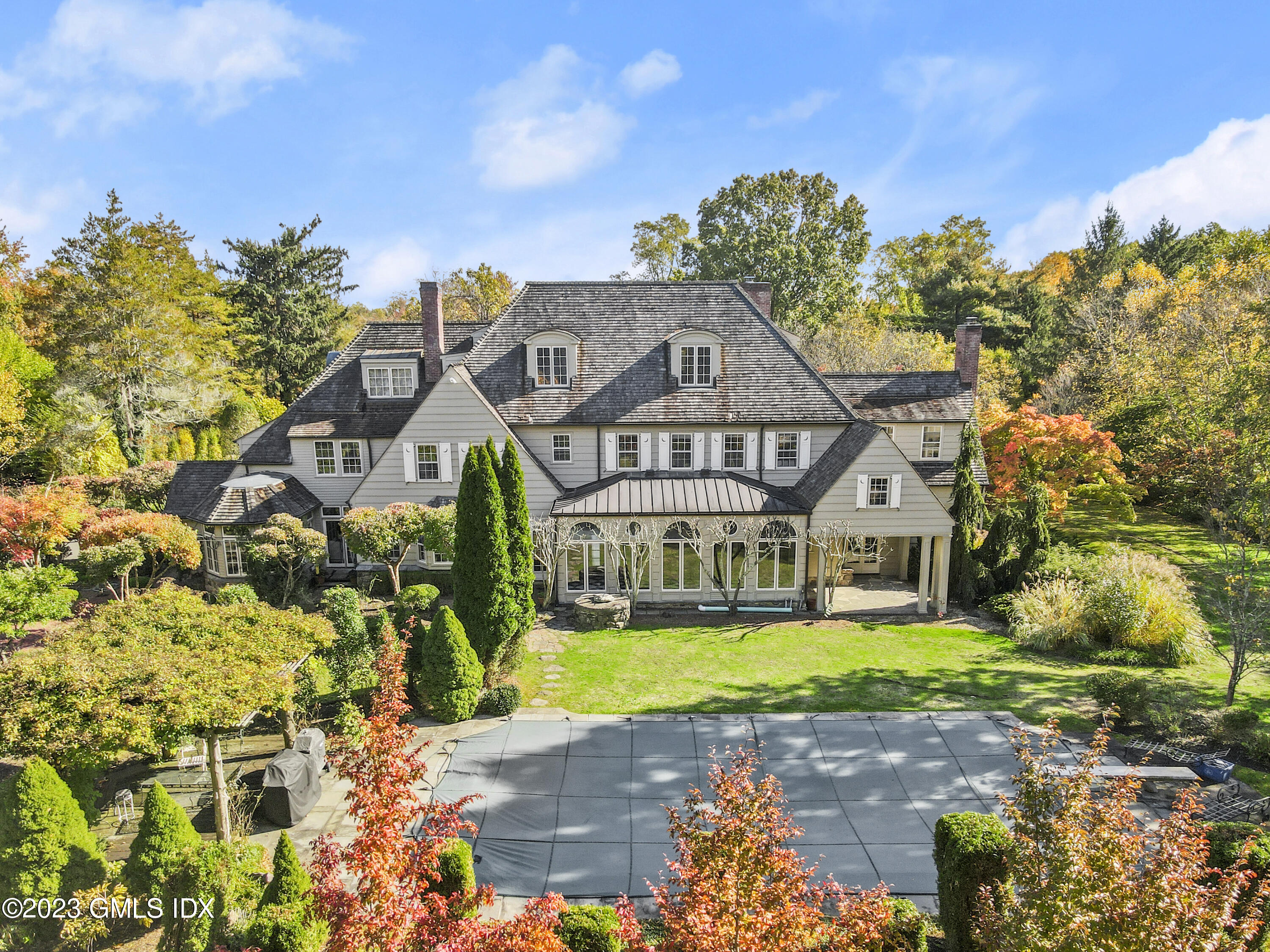 736 Lake Avenue Greenwich, CT 06830 - Photo 4 of 9 a view of a big house with a big yard and potted plants