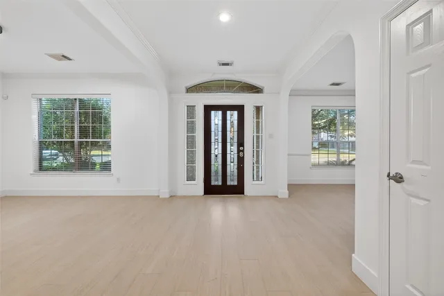 an empty room with windows and closet