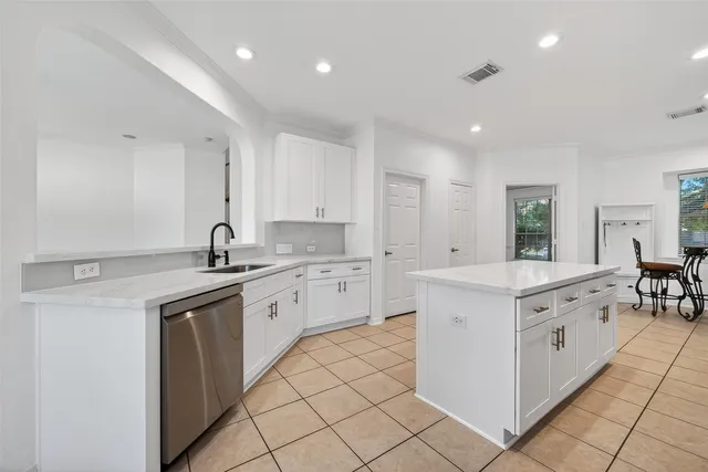 a kitchen with granite countertop white cabinets and white appliances