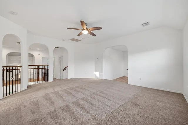 a view of empty room with ceiling fan