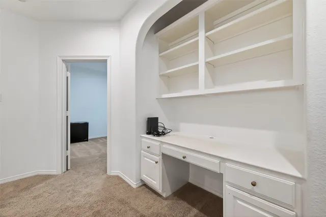 a view of a kitchen with dishwasher and white cabinets