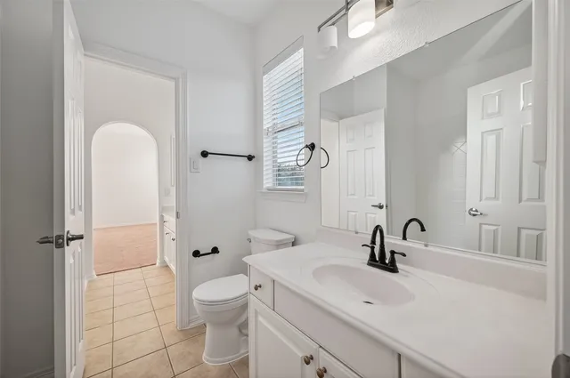 a bathroom with a double vanity sink toilet and shower