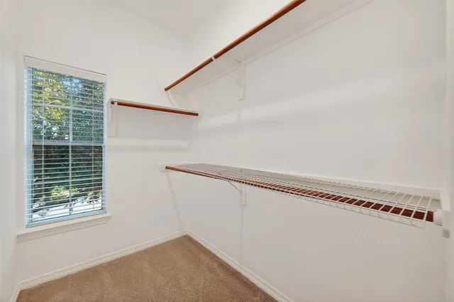 a view of a room with rack on the wall and a window