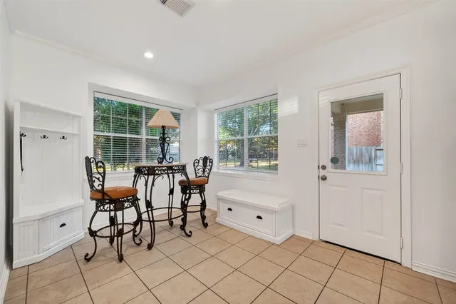 a view of an empty room with window and furniture