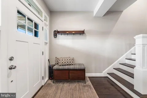 a view of entryway with stairs and wooden floor