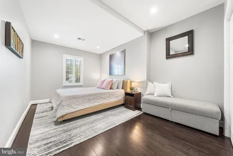 a spacious bedroom with a bed and a couch