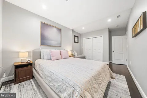 a bedroom with a bed and a night stand