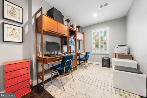 a living room with furniture a window and a flat screen tv
