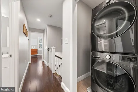 a view of a hallway with washer and dryer