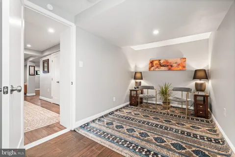 a bedroom with a bed and a view of living room
