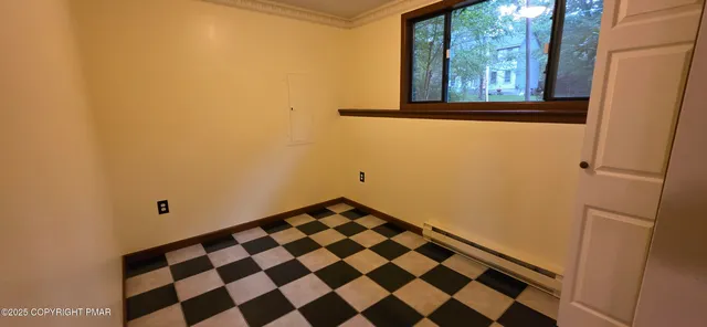 a view of a bathroom with a black white checkered floor