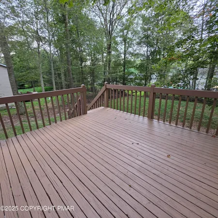 a view of balcony with wooden floor and fence