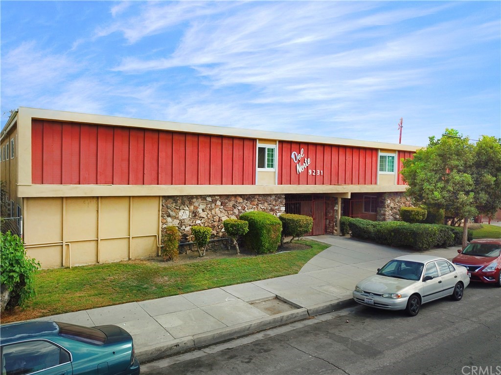 a car parked in front of a house with a yard