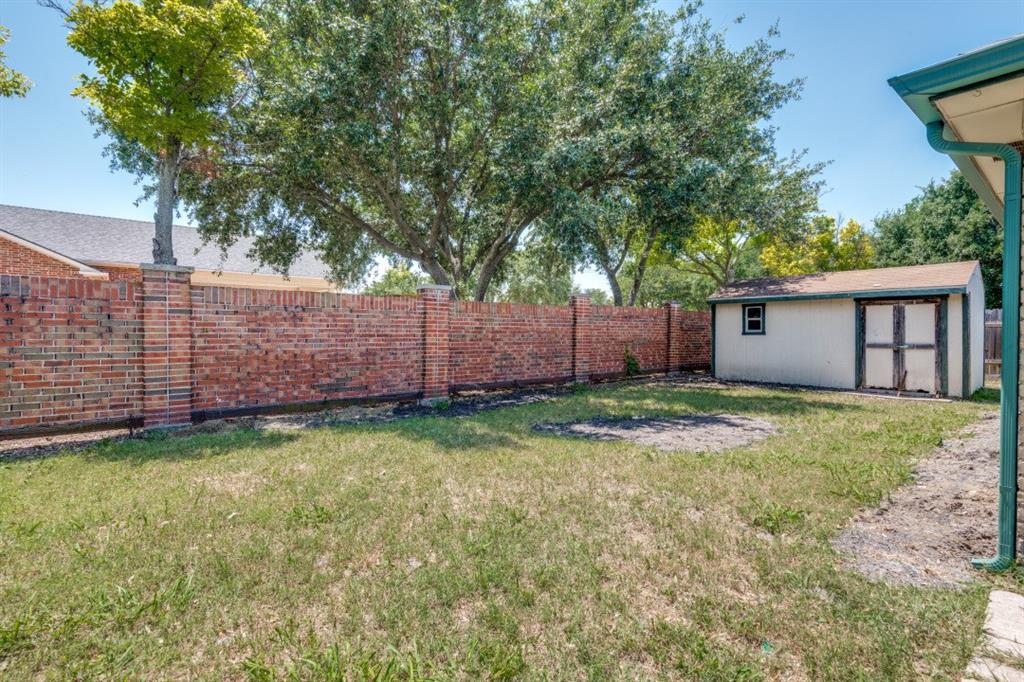 7410 Jessica Way Rowlett, TX 75088 - Photo 24 of 25 a view of a backyard with wooden fence and a large tree