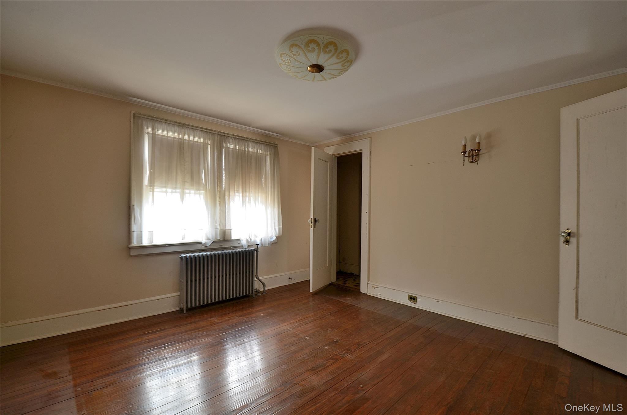 2586 Riverside Drive Wantagh, NY 11793 - Photo 18 of 28 Bedroom featuring hardwood flooring, light-toned walls, white trim