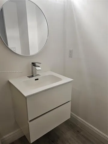a bathroom with a sink and mirror