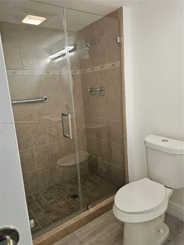 a bathroom with a toilet and a shower