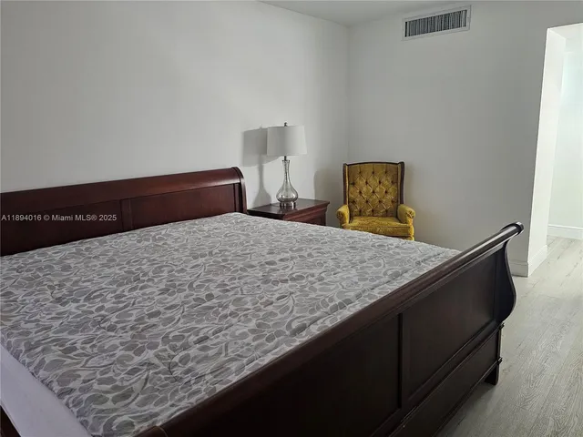 a bedroom with a bed and dresser